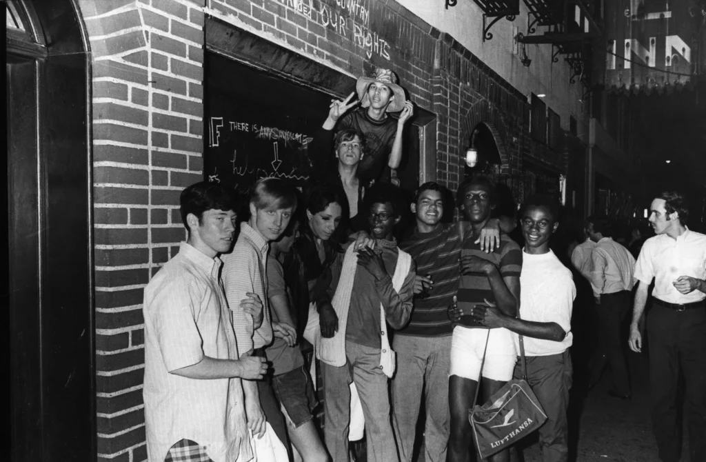 Rioters underneath the Stonewall Inn sign, 1969