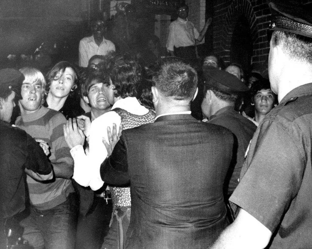 Stonewall Inn nightclub raid. Crowd attempts to impede police. June 28, 1969