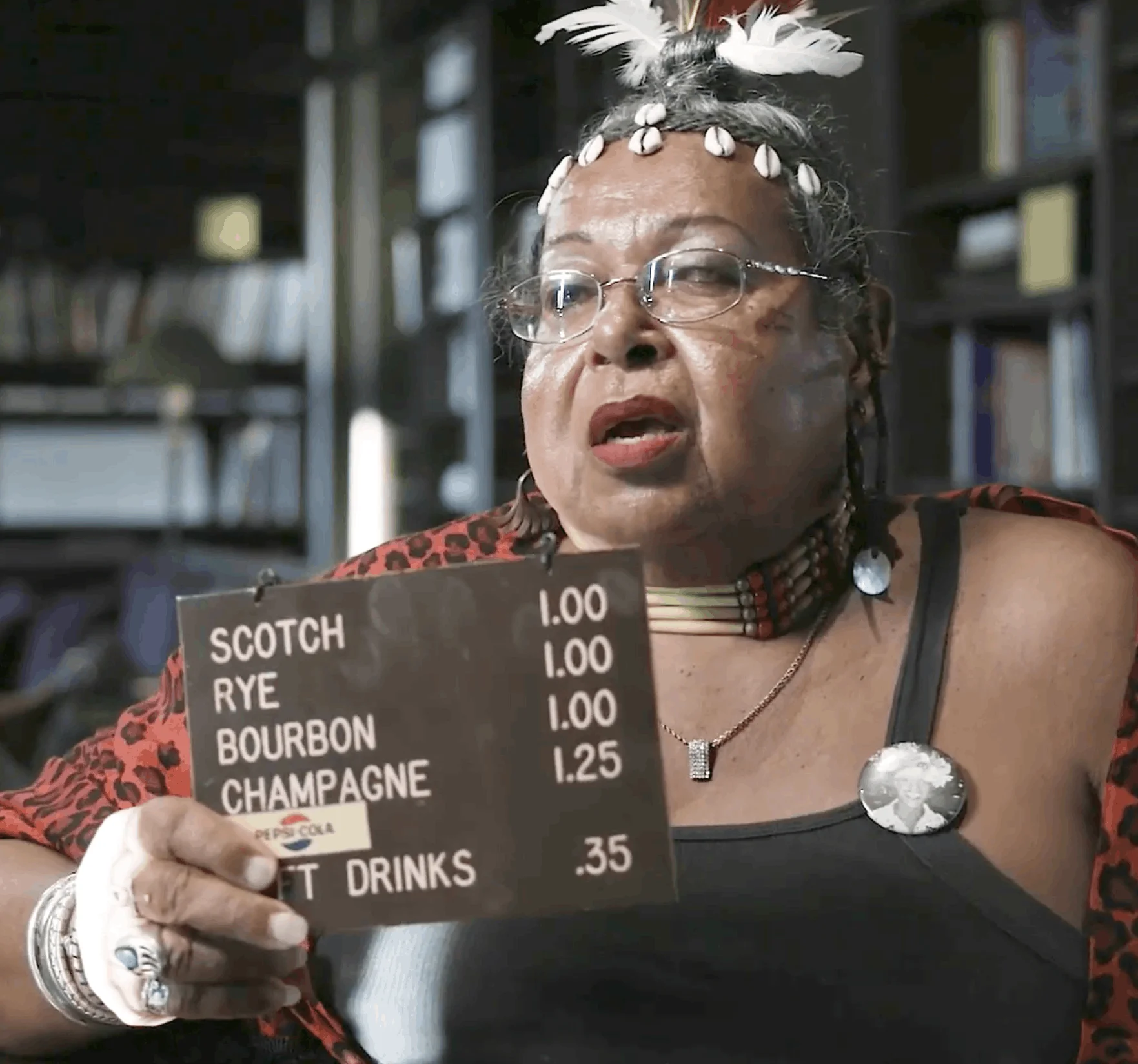 Victoria Cruz with the bar sign from the Stonewall Inn